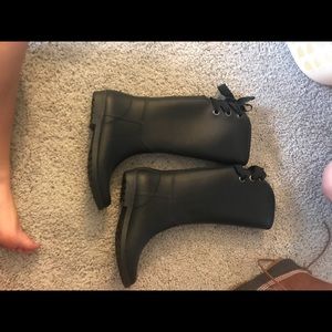 Black rain boots with laces on back
